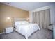 Cozy main bedroom featuring a plush bed with elegant headboard, soft lighting, and neutral tones at 9071 Sunshine Ridge Loop, Kissimmee, FL 34747