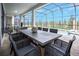 Covered patio with an outdoor dining area featuring a large table and comfortable seating overlooking the pool at 9071 Sunshine Ridge Loop, Kissimmee, FL 34747