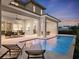 Lovely home exterior featuring a covered patio, a sparkling pool, and comfortable outdoor seating at 9156 Sheen Sound St, Orlando, FL 32836