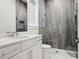 Bathroom featuring a tiled glass-enclosed shower and a large vanity at 9156 Sheen Sound St, Orlando, FL 32836
