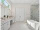 A bathroom featuring double sinks with vanity, shower, and a standalone bathtub at 9156 Sheen Sound St, Orlando, FL 32836