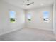 Bright bedroom with three windows offering natural light and outdoor views at 9156 Sheen Sound St, Orlando, FL 32836
