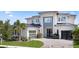 Beautiful modern two-story home featuring a black metal roof, a paved driveway, and a two-car garage at 9156 Sheen Sound St, Orlando, FL 32836