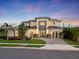 Stunning two-story home featuring a three-car garage, modern design and lush landscaping at 9156 Sheen Sound St, Orlando, FL 32836