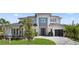 Stunning two-story home with a modern design, lush landscaping, and a paved driveway at 9156 Sheen Sound St, Orlando, FL 32836