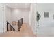 Hallway with modern railing and wood floors leading to carpeted area at 9156 Sheen Sound St, Orlando, FL 32836
