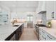 Spacious kitchen with a marble countertop island, stainless steel appliances, and modern cabinets at 9156 Sheen Sound St, Orlando, FL 32836