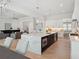 Bright and airy kitchen with a large island, marble countertops, and a view to the open-concept living area at 9156 Sheen Sound St, Orlando, FL 32836