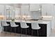 Modern kitchen featuring stainless steel appliances, white cabinets, a large island and stylish pendant lighting at 9156 Sheen Sound St, Orlando, FL 32836