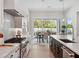 Modern kitchen showcasing a chef's stovetop, marble countertops, and a view into the dining area at 9156 Sheen Sound St, Orlando, FL 32836
