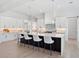 Modern kitchen features a large center island, marble countertops, and stainless steel appliances at 9156 Sheen Sound St, Orlando, FL 32836