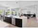A modern kitchen with a large island, stainless steel appliances, and an open view to the living room at 9156 Sheen Sound St, Orlando, FL 32836