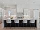 Bright kitchen showcasing an island with marble countertops, modern cabinetry, pendant lighting, and stainless steel appliances at 9156 Sheen Sound St, Orlando, FL 32836