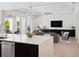 Bright open-concept living space with large island, modern furnishings, and seamless indoor-outdoor flow at 9156 Sheen Sound St, Orlando, FL 32836