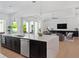 Bright open-concept living space with large island, modern furnishings, and seamless indoor-outdoor flow at 9156 Sheen Sound St, Orlando, FL 32836