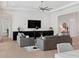 Open living room with modern decor featuring large TV and gray sofas for comfortable seating at 9156 Sheen Sound St, Orlando, FL 32836