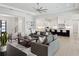 Bright living room showcasing an open layout connecting to the modern kitchen and featuring stylish decor at 9156 Sheen Sound St, Orlando, FL 32836