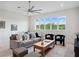 Bright living room with a large window and comfortable gray sofa and stylish decor at 9156 Sheen Sound St, Orlando, FL 32836