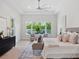 A spacious main bedroom with a ceiling fan, large windows, and bench seating at 9156 Sheen Sound St, Orlando, FL 32836