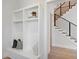 Mudroom area showcasing built-in storage and bench seating with a staircase nearby at 9156 Sheen Sound St, Orlando, FL 32836