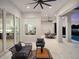 Beautiful covered patio with outdoor seating and a view through the window into the dining area at 9156 Sheen Sound St, Orlando, FL 32836