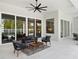 Covered patio featuring outdoor seating, a ceiling fan, tiled flooring and views of the pool at 9156 Sheen Sound St, Orlando, FL 32836
