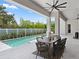 Covered patio featuring an outdoor dining table and a stunning view of the pool with chairs at 9156 Sheen Sound St, Orlando, FL 32836