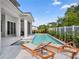Exterior features a pool with a sun shelf, lounge chairs, covered patio and fenced-in backyard at 9156 Sheen Sound St, Orlando, FL 32836