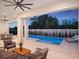Inviting covered patio with a sparkling pool, lounge chairs, and an outdoor ceiling fan at 9156 Sheen Sound St, Orlando, FL 32836