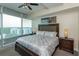 Comfortable bedroom with a large window showcasing city views and soft natural lighting at 101 S Eola Dr # 1021, Orlando, FL 32801