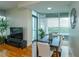 A naturally-lit dining area with wood floors and large windows at 101 S Eola Dr # 1021, Orlando, FL 32801
