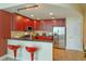 Eat-in kitchen boasting dark wood cabinets, stainless steel appliances, and barstool seating at 101 S Eola Dr # 1021, Orlando, FL 32801