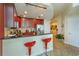 A modern kitchen with dark wood cabinets, stainless appliances, and barstool seating at 101 S Eola Dr # 1021, Orlando, FL 32801