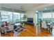 Open living space featuring wood floors, city views from large windows, and modern decor at 101 S Eola Dr # 1021, Orlando, FL 32801