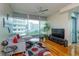 Bright living room with hardwood floors and a stunning city view through large windows at 101 S Eola Dr # 1021, Orlando, FL 32801