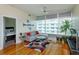 Open living area featuring wood floors, a comfortable sofa, and expansive windows at 101 S Eola Dr # 1021, Orlando, FL 32801