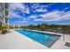 A beautiful outdoor pool with lounge chairs sits under a bright blue sky at this luxury condo building at 101 S Eola Dr # 1021, Orlando, FL 32801