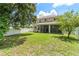 Spacious backyard features a well-maintained lawn and a screened patio at 10142 Serotina Ct, Orlando, FL 32832