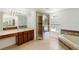 Bright bathroom features a garden tub and a glass door shower at 10142 Serotina Ct, Orlando, FL 32832