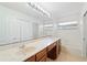 Bathroom featuring dual sinks, a large mirror and a tub at 10142 Serotina Ct, Orlando, FL 32832
