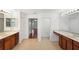 Spacious bathroom features dual vanities with elegant countertops and a large mirror at 10142 Serotina Ct, Orlando, FL 32832