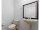 Powder room with pedestal sink and decorative mirror at 10142 Serotina Ct, Orlando, FL 32832