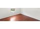 Bedroom features hardwood floors and a window providing natural light at 10142 Serotina Ct, Orlando, FL 32832