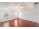 Large bedroom featuring wood floors, ceiling fan, and dual windows at 10142 Serotina Ct, Orlando, FL 32832