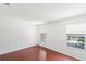 Bedroom featuring hardwood floors and two windows providing natural light at 10142 Serotina Ct, Orlando, FL 32832
