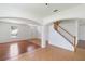 Bright living room featuring hardwood floors, archways, and staircase at 10142 Serotina Ct, Orlando, FL 32832