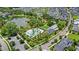 An aerial view showcasing community amenities with a pool, clubhouse and serene pond surrounded by beautiful homes at 102 Hammock Preserve Loop, Winter Garden, FL 34787