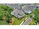 An aerial view of a charming home with a pool, surrounded by lush landscaping and mature trees at 102 Hammock Preserve Loop, Winter Garden, FL 34787