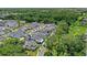 A picturesque aerial view of a neighborhood with tree-lined streets and lush greenery surrounds well-manicured homes at 102 Hammock Preserve Loop, Winter Garden, FL 34787