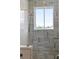 Modern bathroom featuring a shower with blue-green tiles, a window, and modern fixtures at 102 Hammock Preserve Loop, Winter Garden, FL 34787